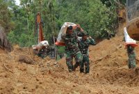 ‎Prajurit berjalan kaki memukul bantuan menembus wilayah terisolir untuk menyalurkan bantuan logistik di Kecamatan Sitahuis, Kabupaten Tapanuli Tengah